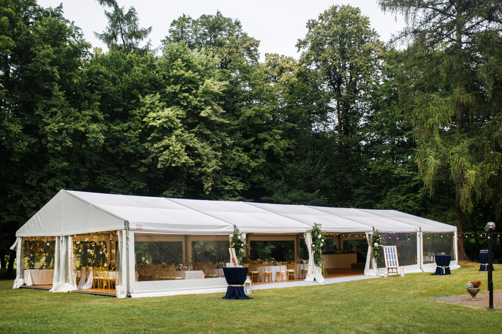 Long,white,tent,for,wedding,party,in,the,woods.